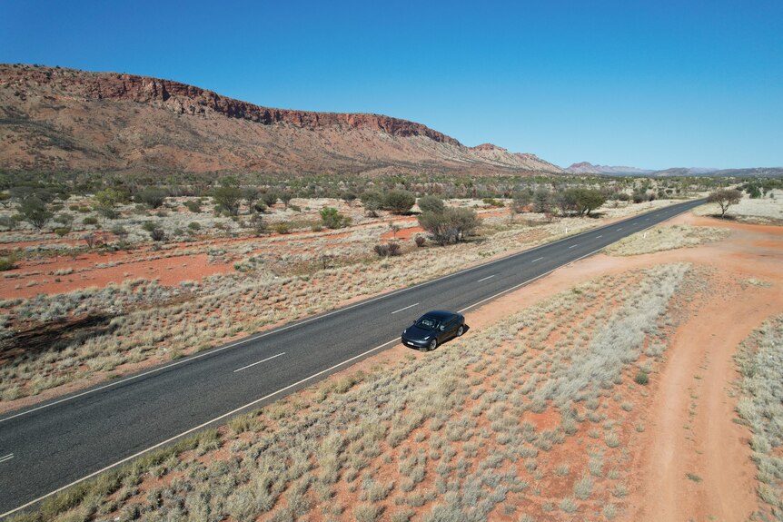 A vehicle on the edge of an outback highway.