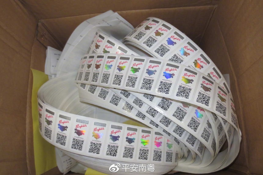 A box filled with a roll of anti-counterfeit labels.