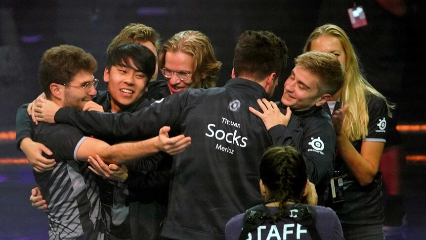 The team OG celebrate by hugging after winning The International in Shanghai.