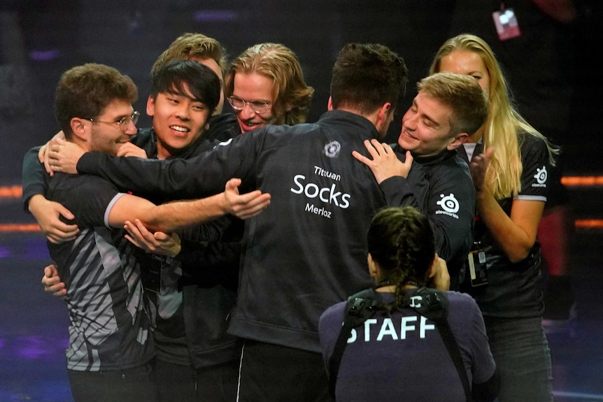 The team OG celebrate by hugging after winning The International in Shanghai.
