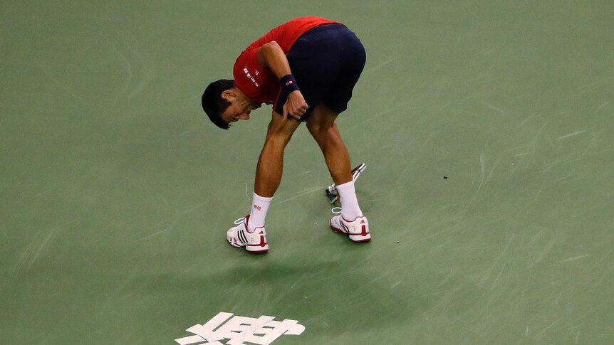 Novak Djokovic smashes a racket while playing against Roberto Bautista Agut