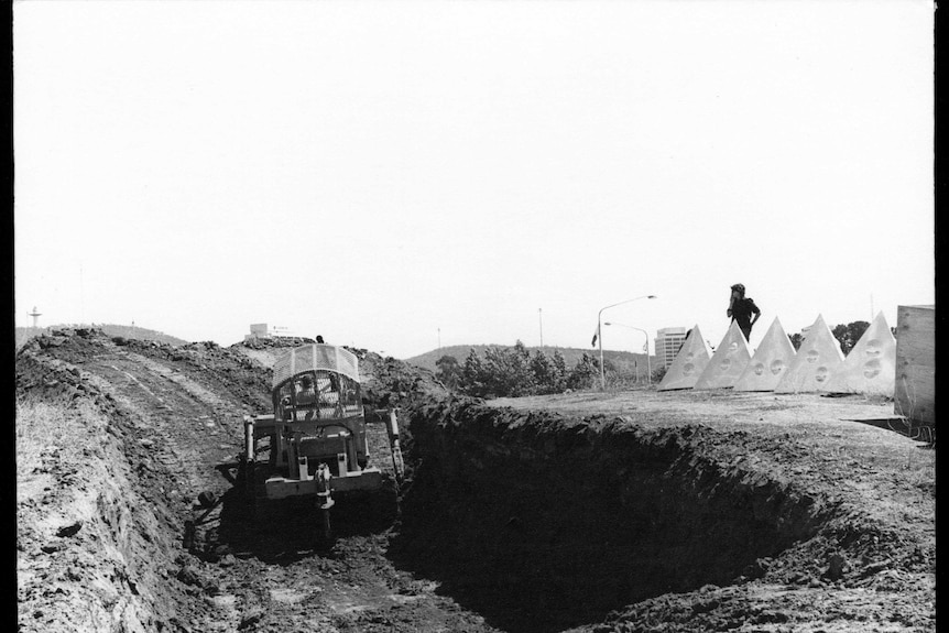 A hole is dug ready for the Earthwork sculpture that features six polished aluminium tetrahedrons.