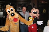 Former public servant Ian Ralph Schapel with Pluto and Mickey Mouse