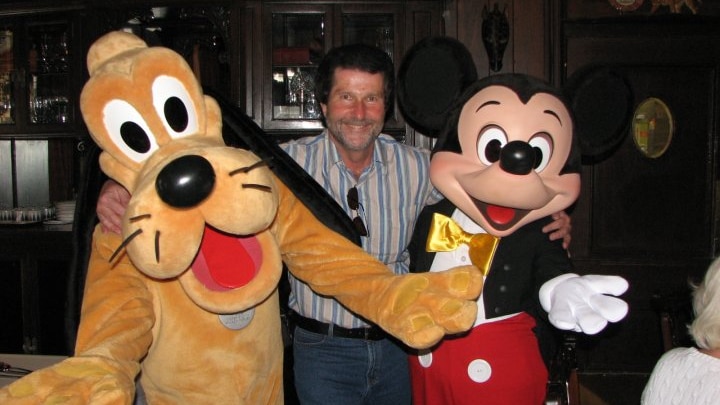 Former public servant Ian Ralph Schapel with Pluto and Mickey Mouse