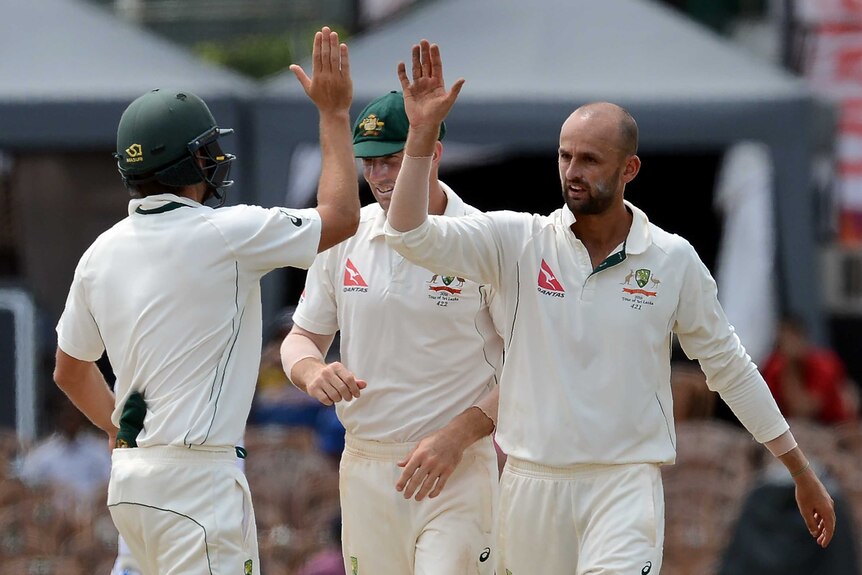 Nathan Lyon celebrates taking a wicket.