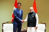 Justin Trudeau shaking hands with Narendra Modi. 