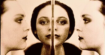 A mirror image shows women's faces.