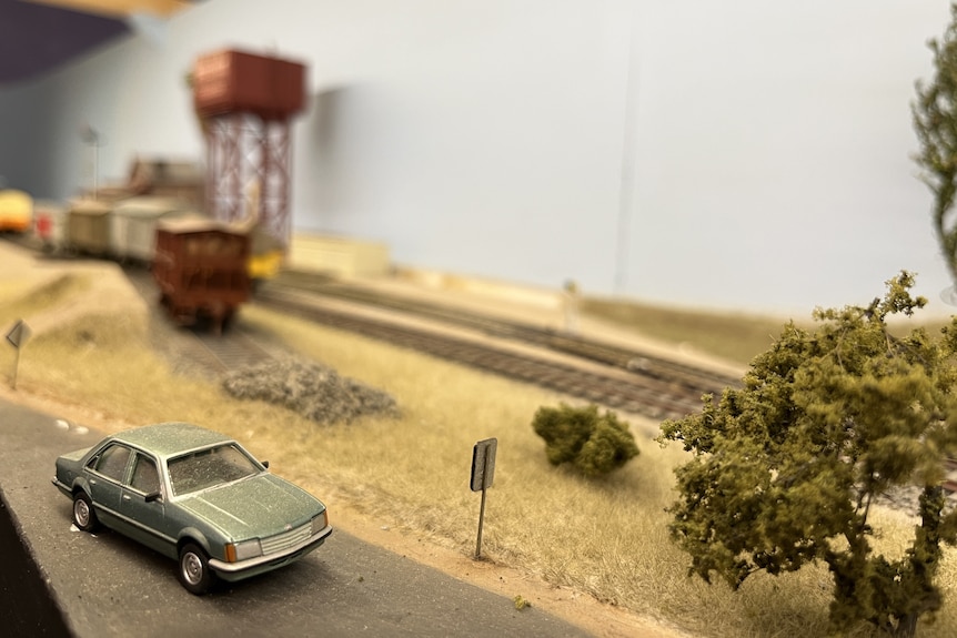A model of a VH Commodore car from the 1980s next to model railway track