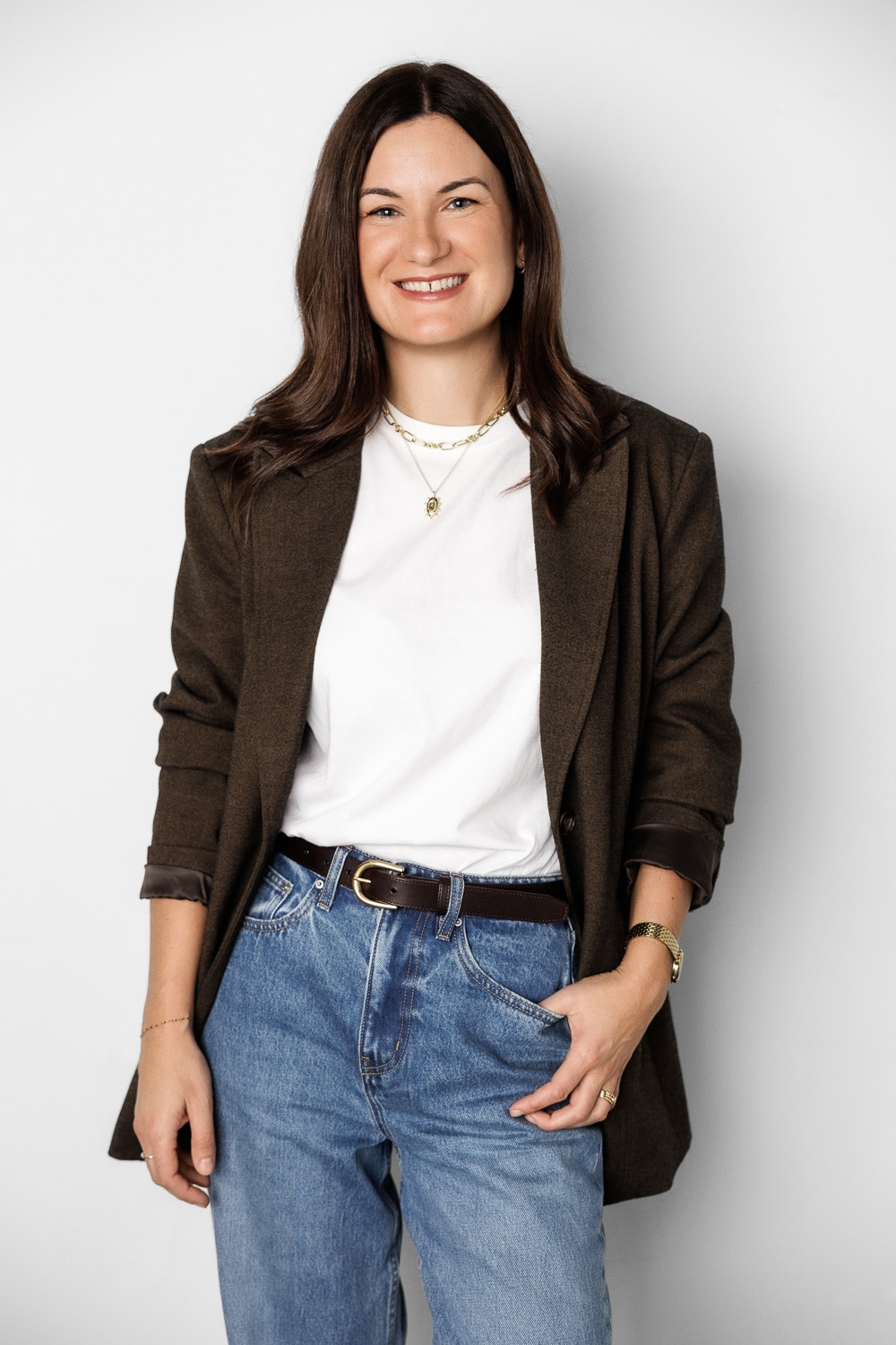 A smiling, dark-haired woman poses for a corporate headshot.