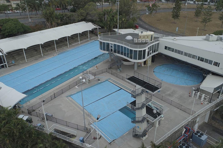 Aerial shot of public pool complex with high diving platform