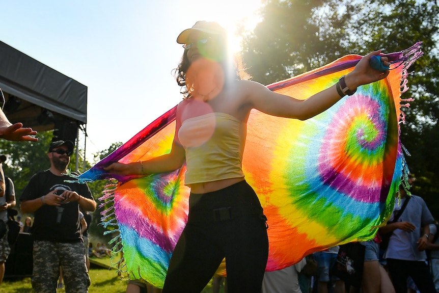 A woman dances with a rainbow flag during the Hungary Pride parade