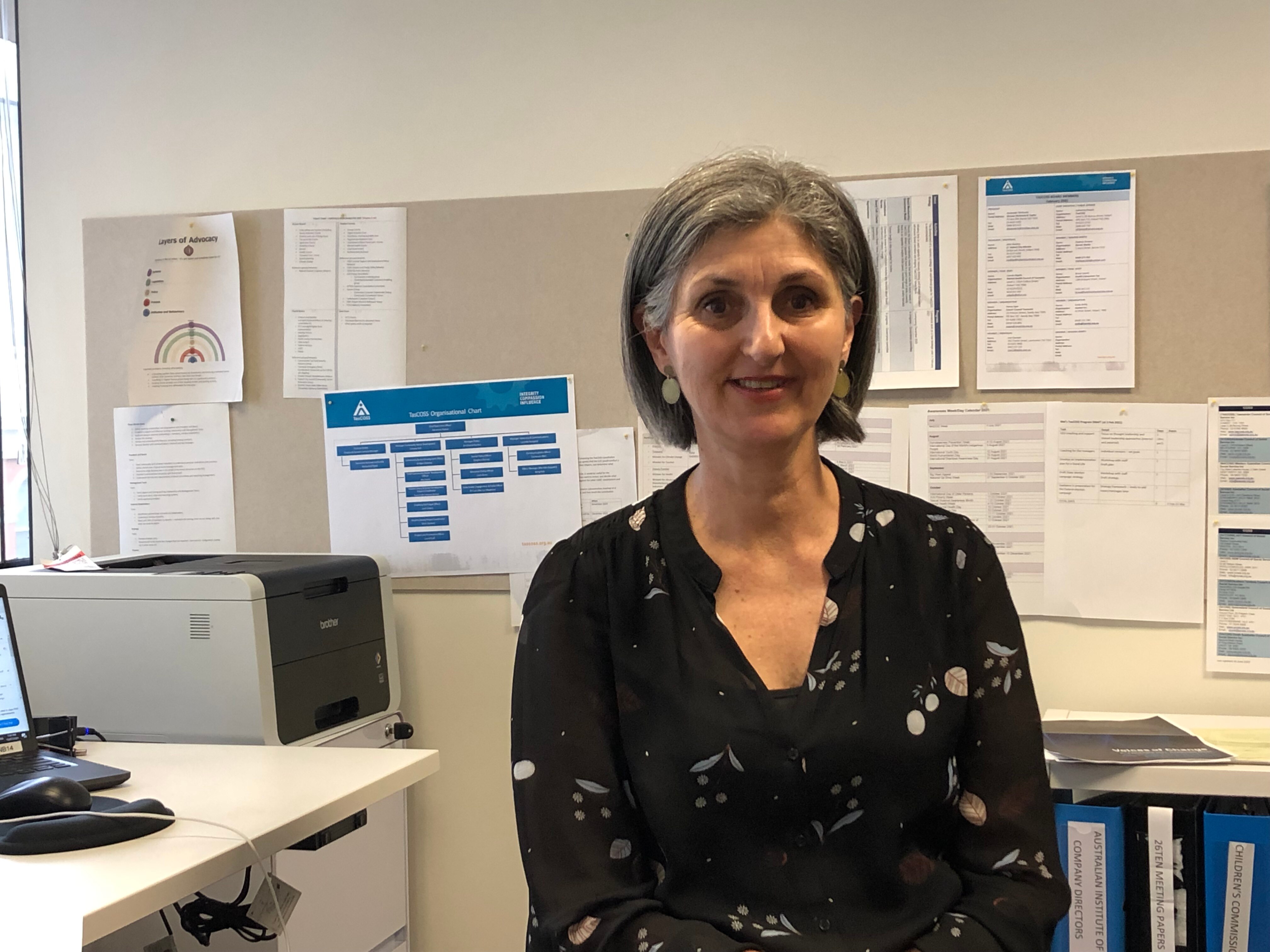 A woman sitting in the office.