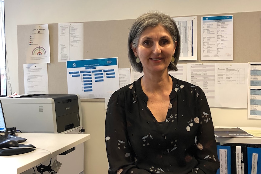 A woman sitting in the office.