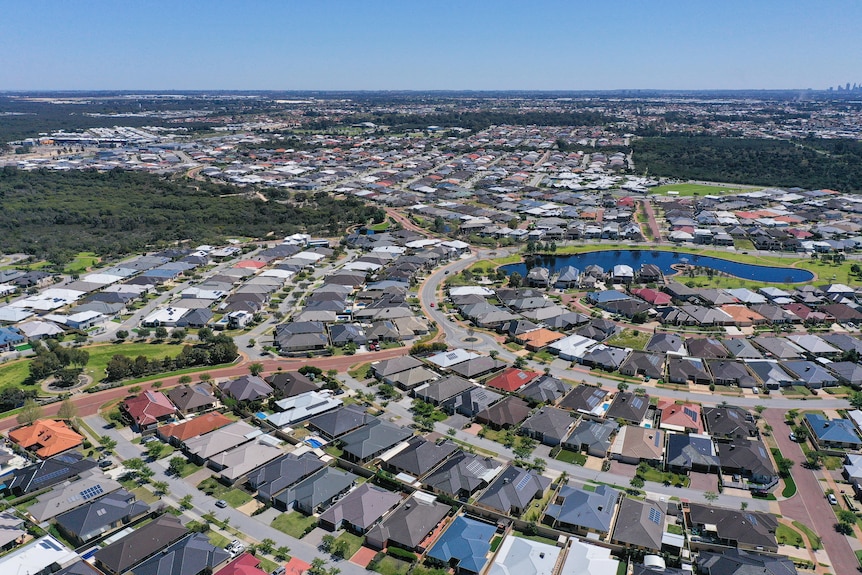 Drone shot of suburb including roofs with solar panels