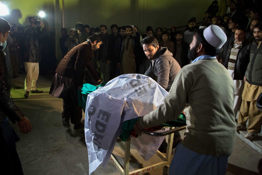 Volunteers work at the scene of a plane crash in Pakistan