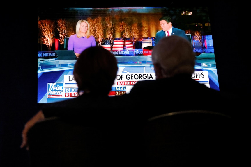 Guests watch news coverage of the run-off election for Georgia’s two Senate seats.