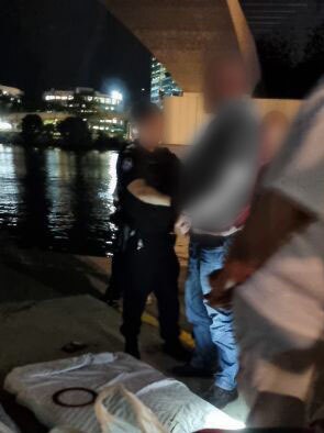 Teisha Keley's friend being handcuffed by police at Go Between Bridge