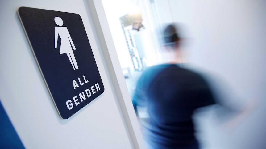 A bathroom sign welcomes all genders at a coffee shop in North Carolina