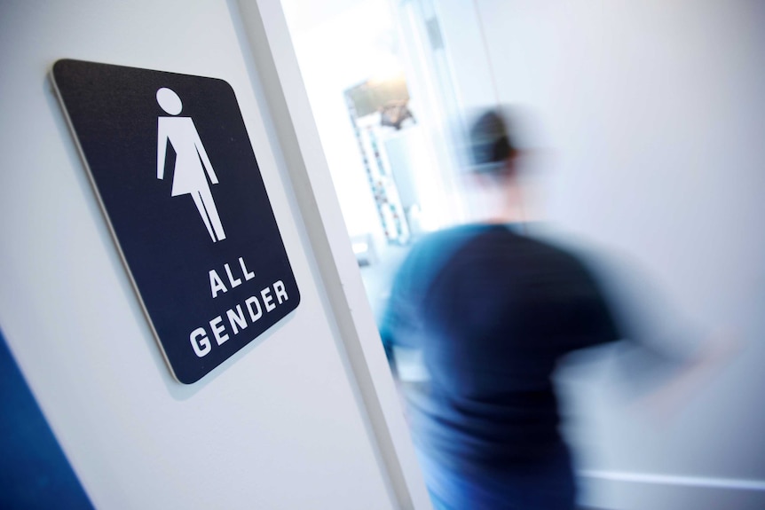 A bathroom sign welcomes all genders at a coffee shop in North Carolina