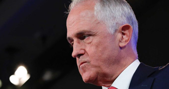 Prime Minister Malcolm Turnbull looks agitated and angry.