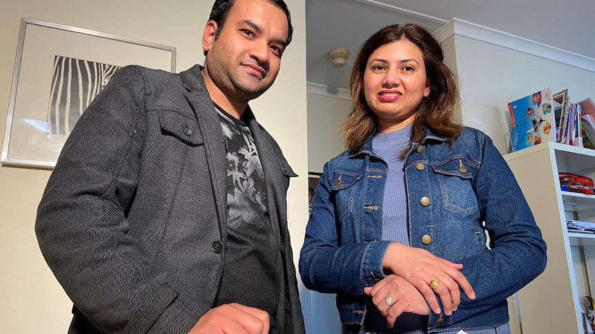 a man and a woman looking at home loan documents