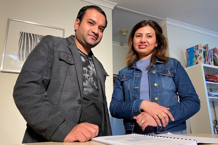 a man and a woman looking at home loan documents