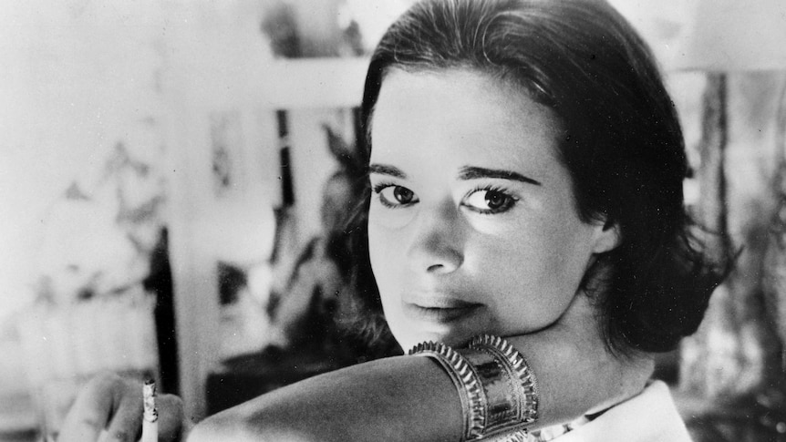 Black and white photo of a young Gloria Vanderbilt looking directly at the camera
