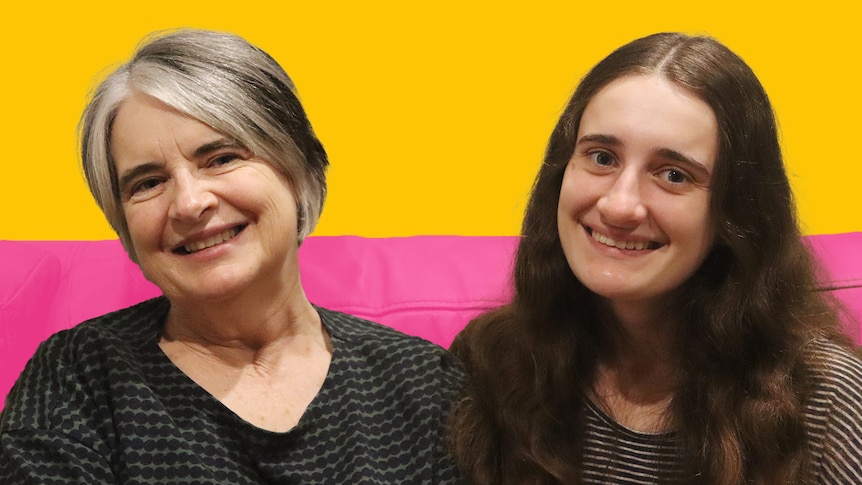 Mum and daughter Helen and Lucy smile in front of a colourful background.