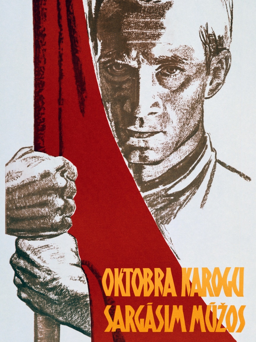 A poster depicting a man holding a red flag.