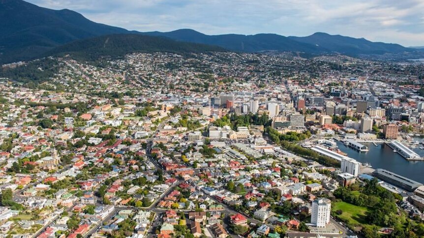 An aerial view of Hobart from the harbour to the mountains.