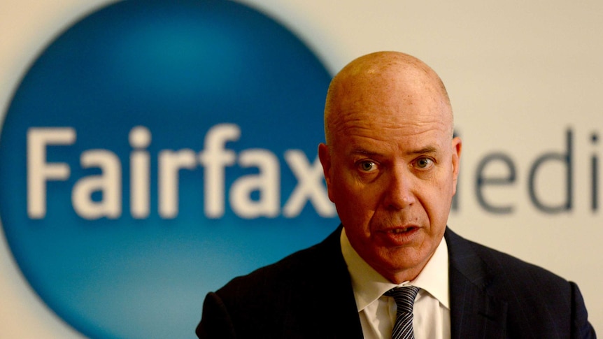 Fairfax CEO Greg Hywood in front of the a Fairfax Media sign