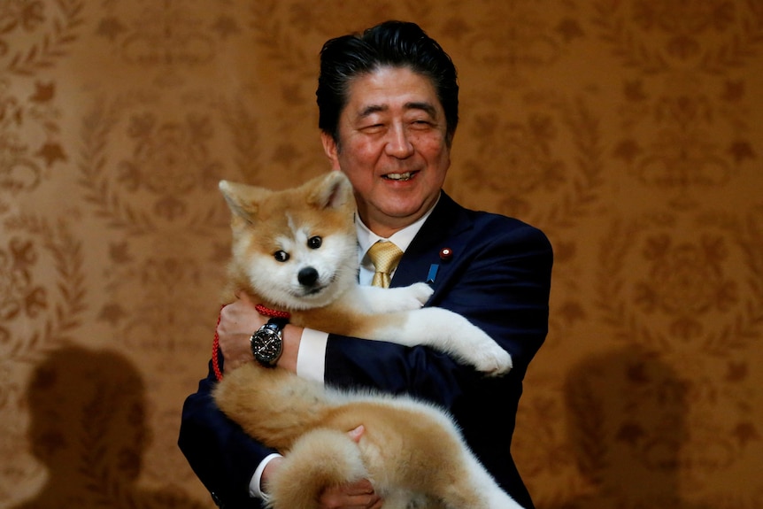 Former Prime Minister Shinzo Abe and his dog.