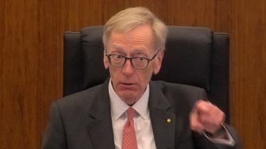Commissioner Kenneth Hayne points a finger at NAB counsel Neil Young QC during a hearing on August 8, 2017.