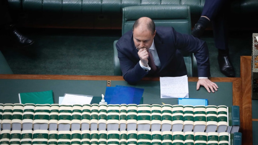 High angle of Frydenberg leaning forward, hand on chin.