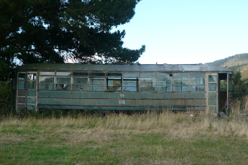 Tram 116 in a paddock in Hobart in desperate need of some maintenance