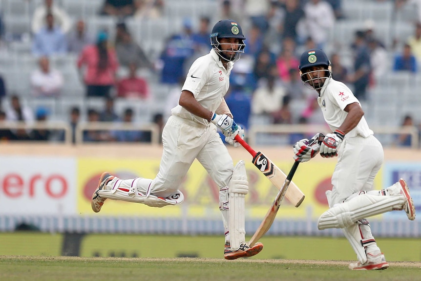 Cheteshwar Pujara and Wriddhiman Saha run between the wickets