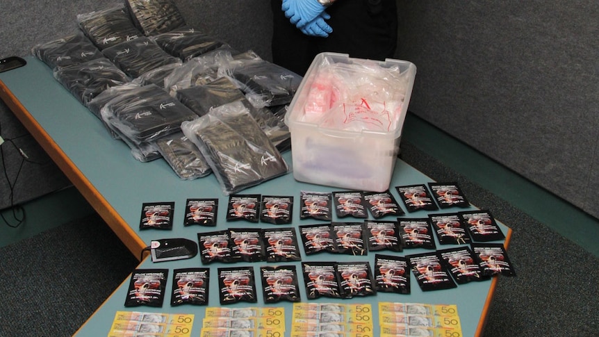 Police in Mount Isa in north-west Qld seize synthetic cannabis and money in drug bust on May 7, 2013.