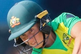A female Australian cricketer hits to the off side as the Sri Lanka wicketkeeper looks on during the ODI.