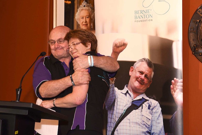 Rod Smith and Karen Banton hug on stage