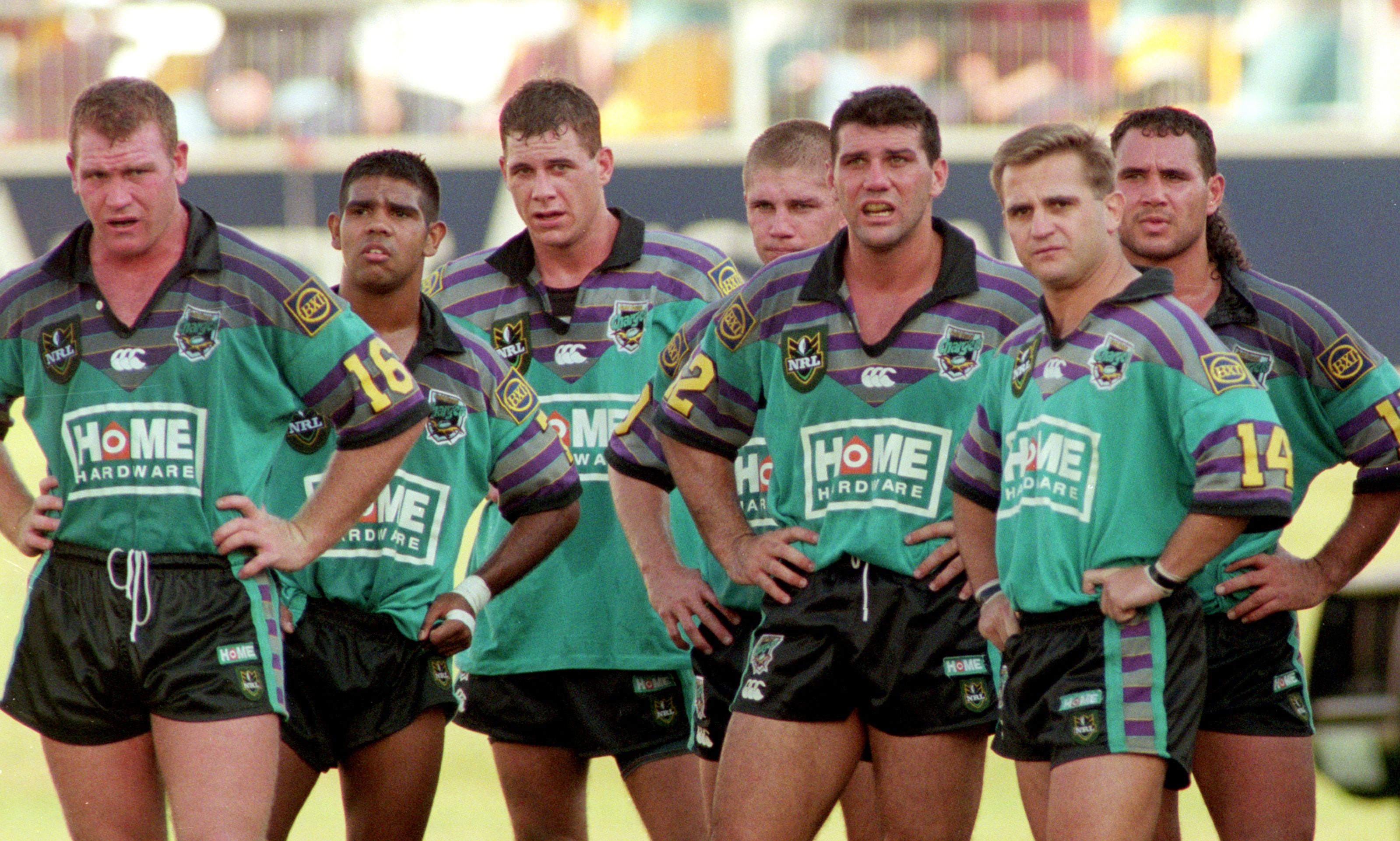 A group of rugby league players look despondent after conceding a try 