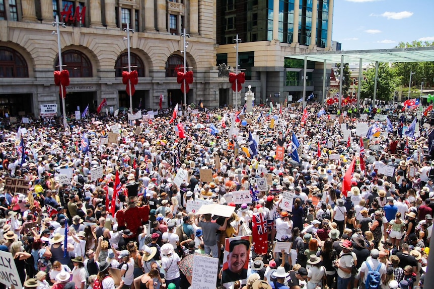 Thousands of people packed tightly and protesting with placards.