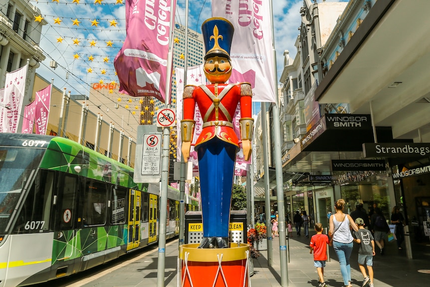 Giant toy soldier in front of Melbourne tram.