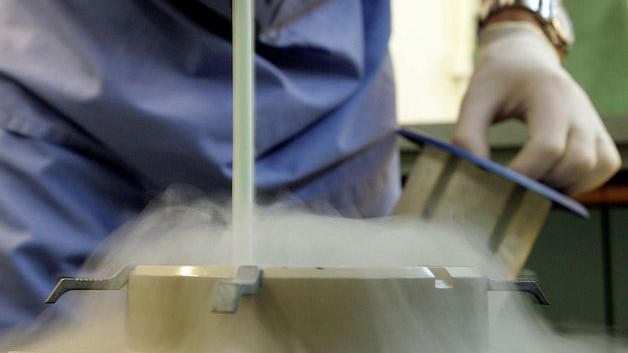 A doctor prepares eggs and sperm in a freezing facility.