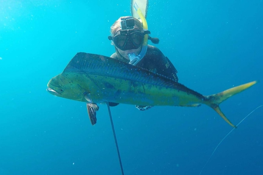 Kate Rogers with a mahi-mahi  fish she caught while spearfishing