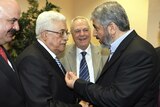 Hamas leader Khaled Meshaal (R) shakes hands and speaks with president Mahmoud Abbas (L) during thei