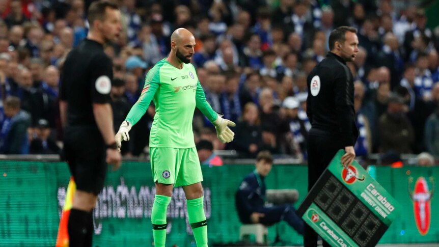 Willy Caballero stands with his hands outstretched on the sideline