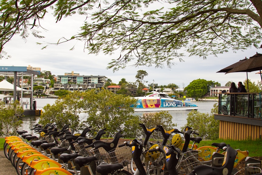 The New Farm CityCat stop sits next to cafes and bike stands as part of the popular New Farm park