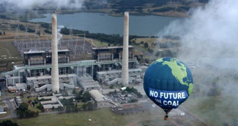 A hot air balloon, saying "no future in coal", floats close to the Liddell power station.