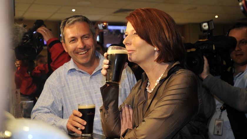Jim Arneman shares a drink with the then Prime Minister Julia Gillard during his campaign for the seat of Paterson in 2010.