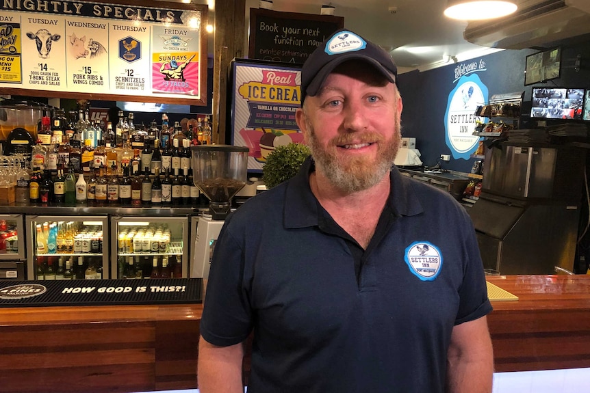 Publican stand behind his bar